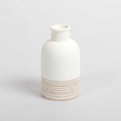 a white vase sitting on top of a table