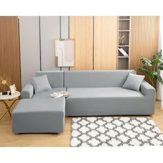 a living room with a sectional couch and ottoman