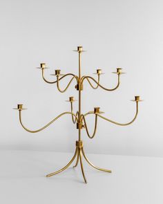 a gold candelabra with six candles on it's sides and four arms