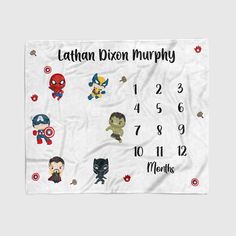 a white blanket with avengers and spiderman characters on it, which reads latinn dixion murphy