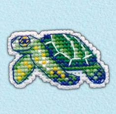 a green turtle with yellow dots on it's shell is shown in the shape of a sticker