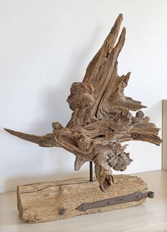 a piece of driftwood sitting on top of a wooden table