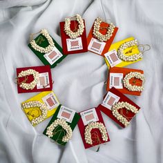 a wreath made out of cards and beads on a white sheet with the word love spelled in it