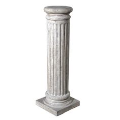 an old white marble column on a pedestal