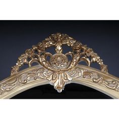 an ornate gold mirror frame on a black background