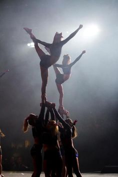 a group of women standing on top of each other