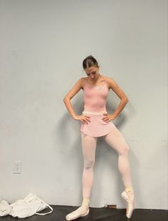 a woman in pink ballet outfit posing for the camera