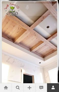 an instagram photo of a room with wooden ceiling beams and white paint on the walls