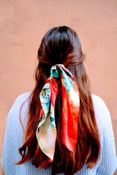 a woman with long hair wearing a colorful scarf