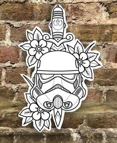 a sticker on the side of a brick wall with a helmet and flowers around it