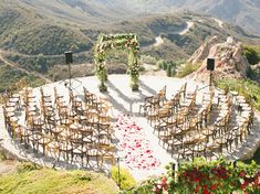 an outdoor ceremony set up with chairs and flowers