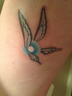 a small tattoo on the leg of a woman's thigh with an image of a bird