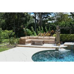 an outdoor living area with a fountain and couches