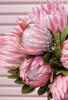 a bouquet of pink flowers sitting on top of a table