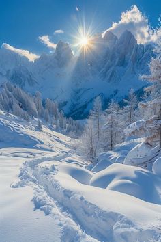 the sun shines brightly over snow covered mountains