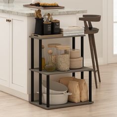 three tiered shelving unit in a kitchen