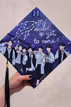 a hand holding up a graduation cap with the words, my moment is yet to come