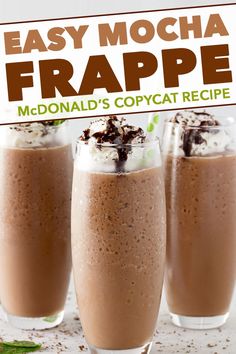 three glasses filled with chocolate frappe and topped with whipped cream, sprinkles and mint