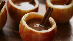 apples with cinnamon sticks sticking out of them