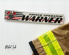 a sticker that says driver operator warnner next to an orange fireman's uniform