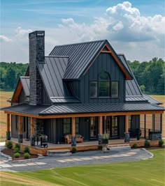 a large house with a metal roof in the middle of a field