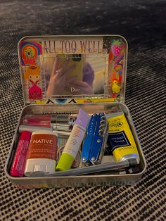 an open tin with various items in it