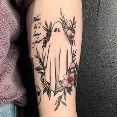 a woman with a tattoo on her arm has a white bird and flowers around it