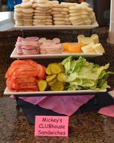 three tiered trays filled with different types of food on top of a counter