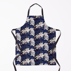 a blue apron with white flowers on it