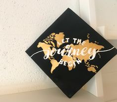 a black and gold graduation cap that says let the journey begin