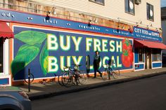 there are many bicycles parked in front of the building that sells fresh bicyclists