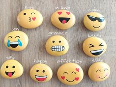 a bunch of smiley faces painted on rocks with words that say happy, smile, love, joy