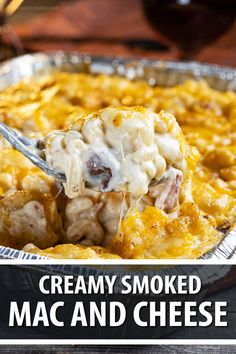 a spoon full of macaroni and cheese being lifted from a casserole dish