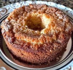 a bundt cake sitting on top of a white and black plate covered in powdered sugar