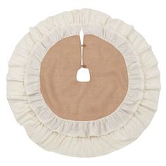 a round rug with ruffled edges and a beige circle in the center on a white background