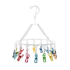 a multicolored hanger with scissors hanging from it's hooks on a white background