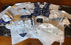 several different types of baby clothes laid out on a table