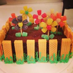 a cake decorated with candy and flowers on a plate