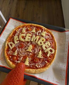 a pizza with the word december spelled on it sitting on top of a paper towel