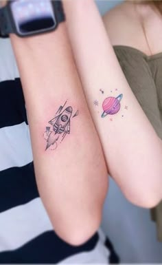 two girls with matching tattoos on their arms