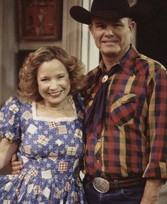 an older man and young woman standing next to each other