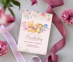 a pink birthday party with pooh and tiggers on the front, along with flowers