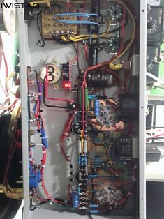 the inside of an electrical panel with many wires and other electronic equipment in it,