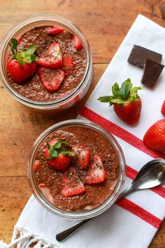 two bowls filled with chocolate pudding and strawberries