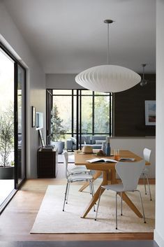 a dining room table with white chairs around it