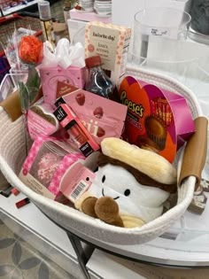 a white basket filled with lots of different types of stuff animals and other things in it