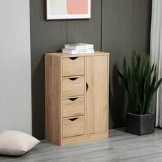 a wooden cabinet sitting next to a potted plant