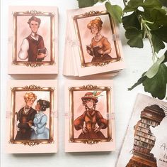 four coasters with pictures of people on them next to a potted plant and some books