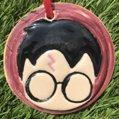 a harry potter ornament hanging in the grass