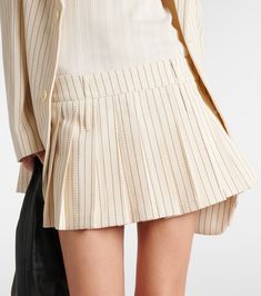 Blake pleated pinstripe twill miniskirt in neutrals - The Frankie Shop | Mytheresa Chic Formal Mini Skirt With Accordion Pleats, Accordion Pleated Skort For Work, Accordion Pleated Skort For Workwear, Accordion Pleats Skort For Workwear, Chic Striped Fitted Skort, Chic Fitted Striped Skort, Accordion Pleats Mini Skirt For Workwear, Workwear Mini Skort With Pleated Hem, Workwear Bottoms With Pleated Waist And Mini Length